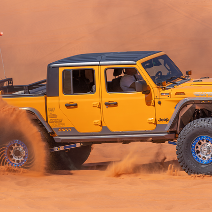 Jeep Gladiator JT with Savvy Krawler Lite weld-on rock sliders on boulder, hardcore rock crawling rocker protection