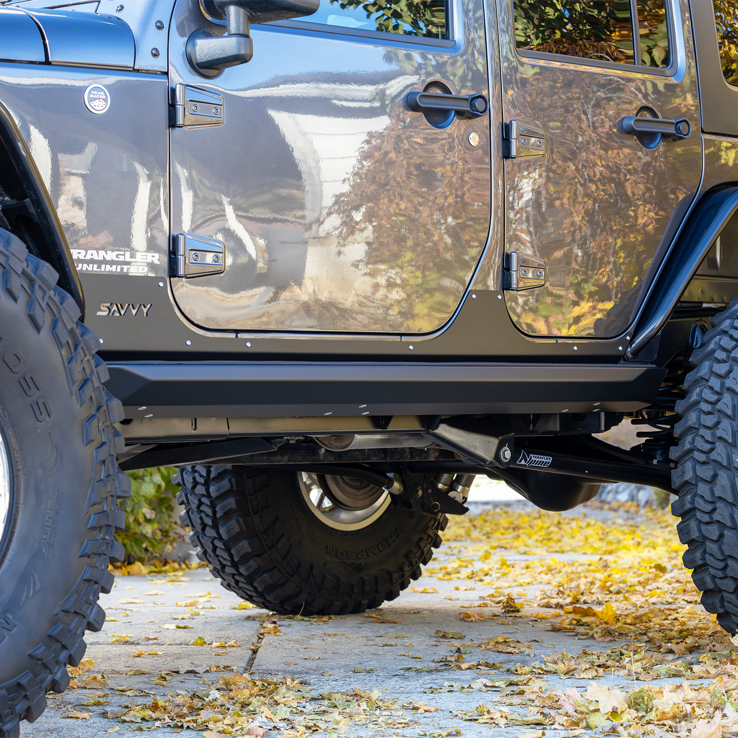 bolt-on sliders tight high-clearance fit against Jeep Wrangler JKU body, no-snag low-profile design