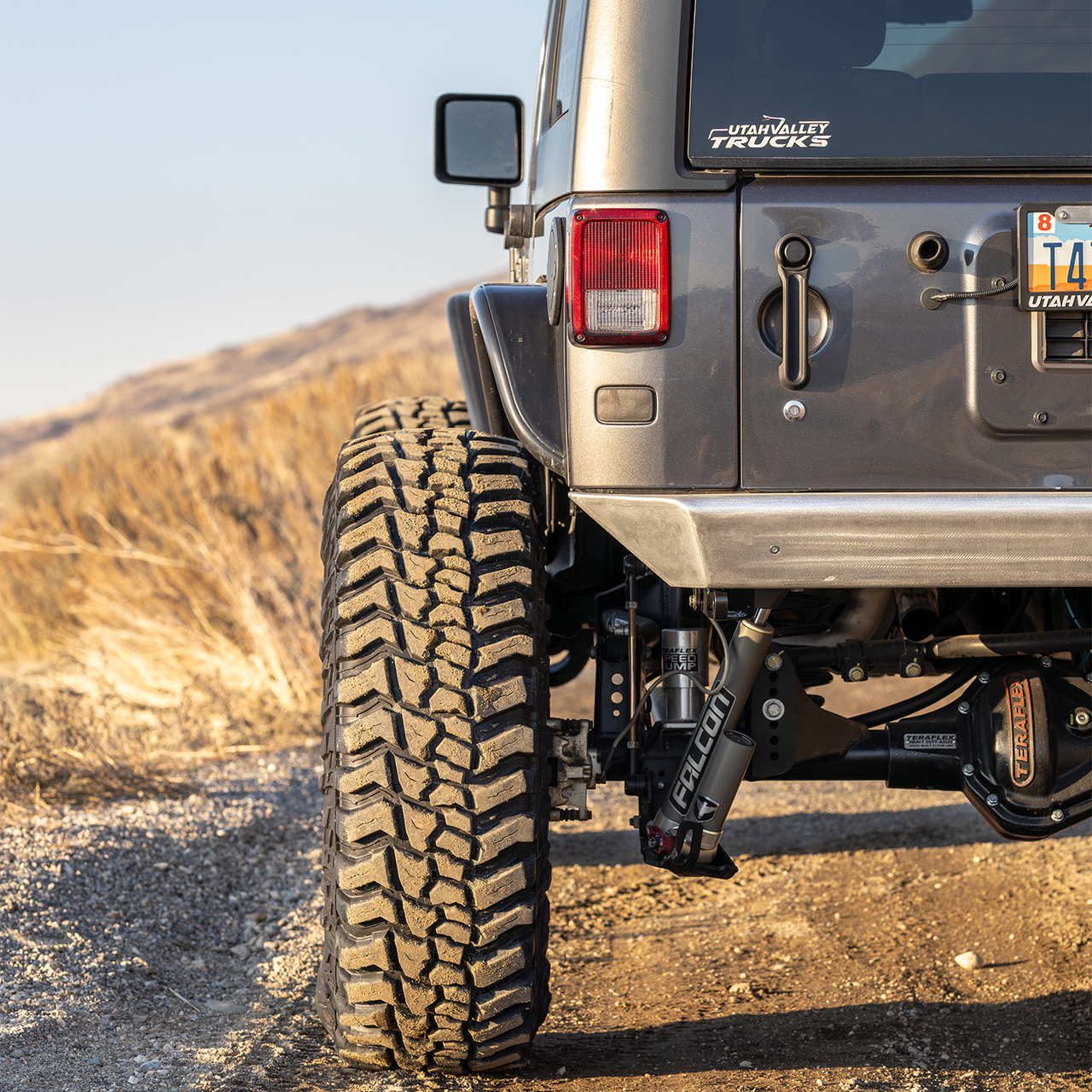 Jeep Wrangler JKU using Savvy LEGACY ELITE armor bundle on an off-road trail with high-clearance bumpers, sliders, and inner fenders