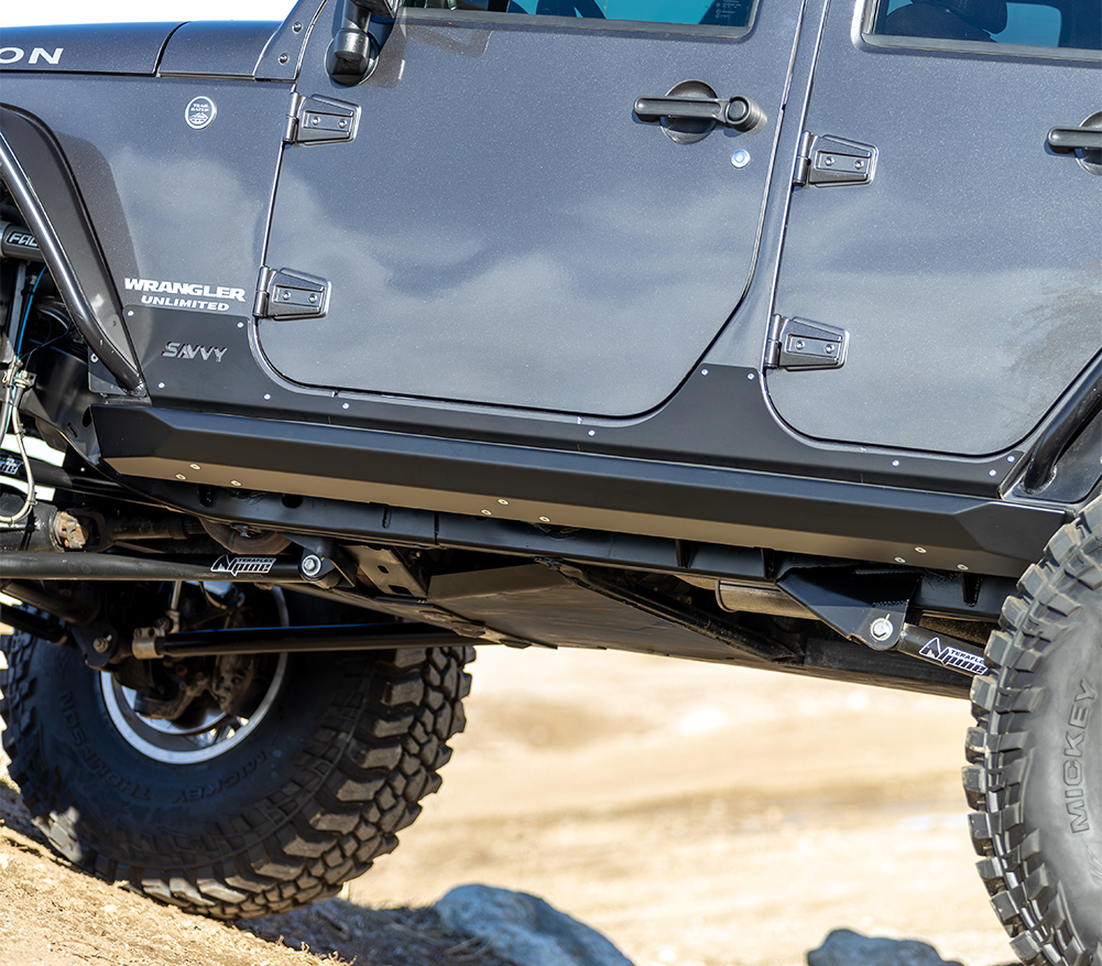 Savvy Offroad KRAWLER LITE bolt-on rock sliders with 3/16-inch CNC laser-cut steel construction, replaceable body skins, and high-clearance low-profile design on 2007–2018 Jeep Wrangler JKU
