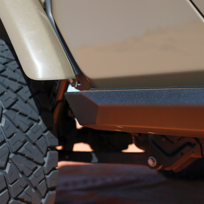 Close-up of Savvy Offroad KRAWLER LITE Jeep Gladiator JT bolt-on rock slider showing wide low-profile step surface and CNC laser-cut steel bracket