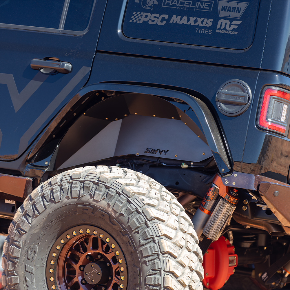 Savvy Offroad high-clearance 16-gauge aluminum rear inner fenders protecting fuel lines and wiring with bolt-on installation on 2018–2026 Jeep Wrangler JLU