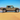 Jeep Gladiator JT equipped with Savvy Offroad LEGACY front bumper with hoop, BIG 10 rear bumper, and KRAWLER LITE bolt-on rock sliders on extreme off-road terrain